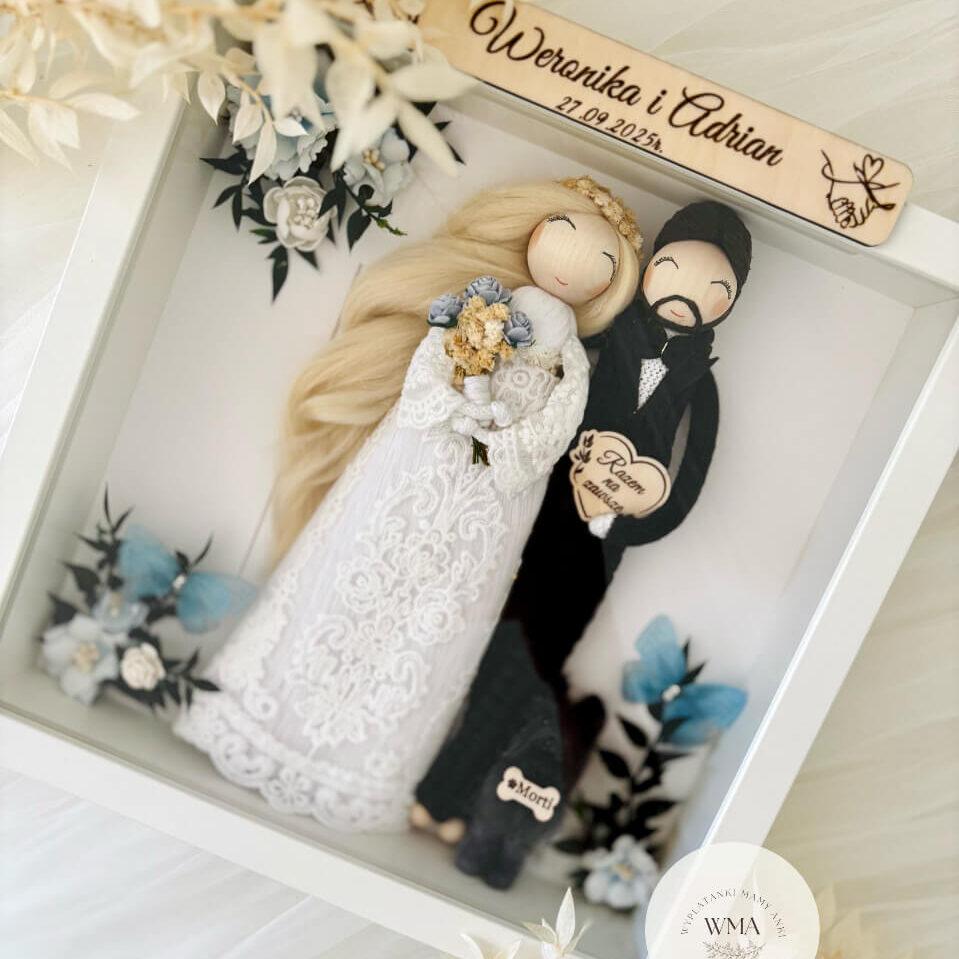Personalizowana ramka ślubna z figurkami pary młodej - panna młoda z długimi blond włosami w sukni koronkowej z niebieskim bukietem, pan młody z brodą w czarnym garniturze, drewniana tabliczka z imionami i datą ślubu, dekoracja w kolorach błękitnym i złotym, handmade